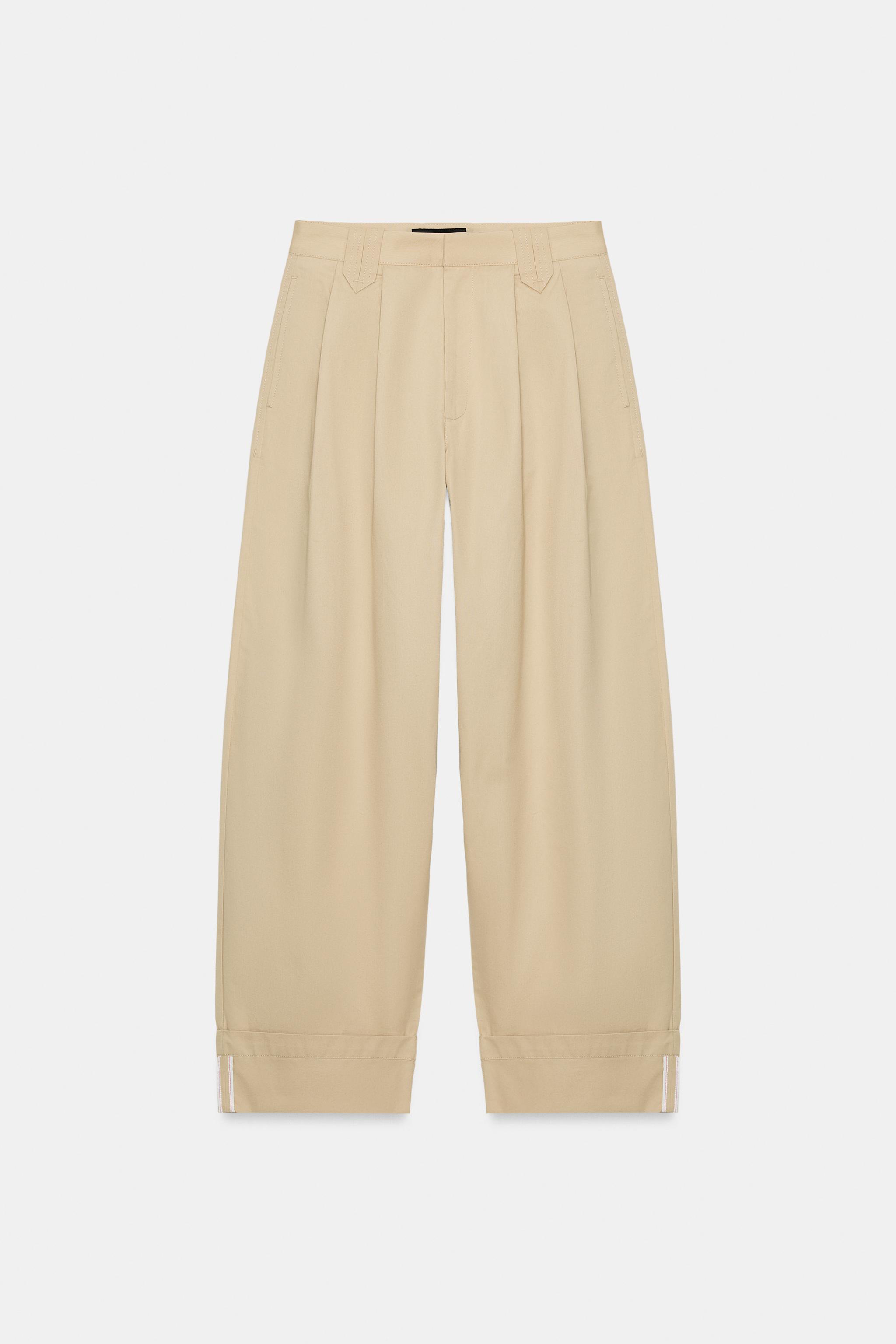 PANTALON À PINCES ET BAS REVERS